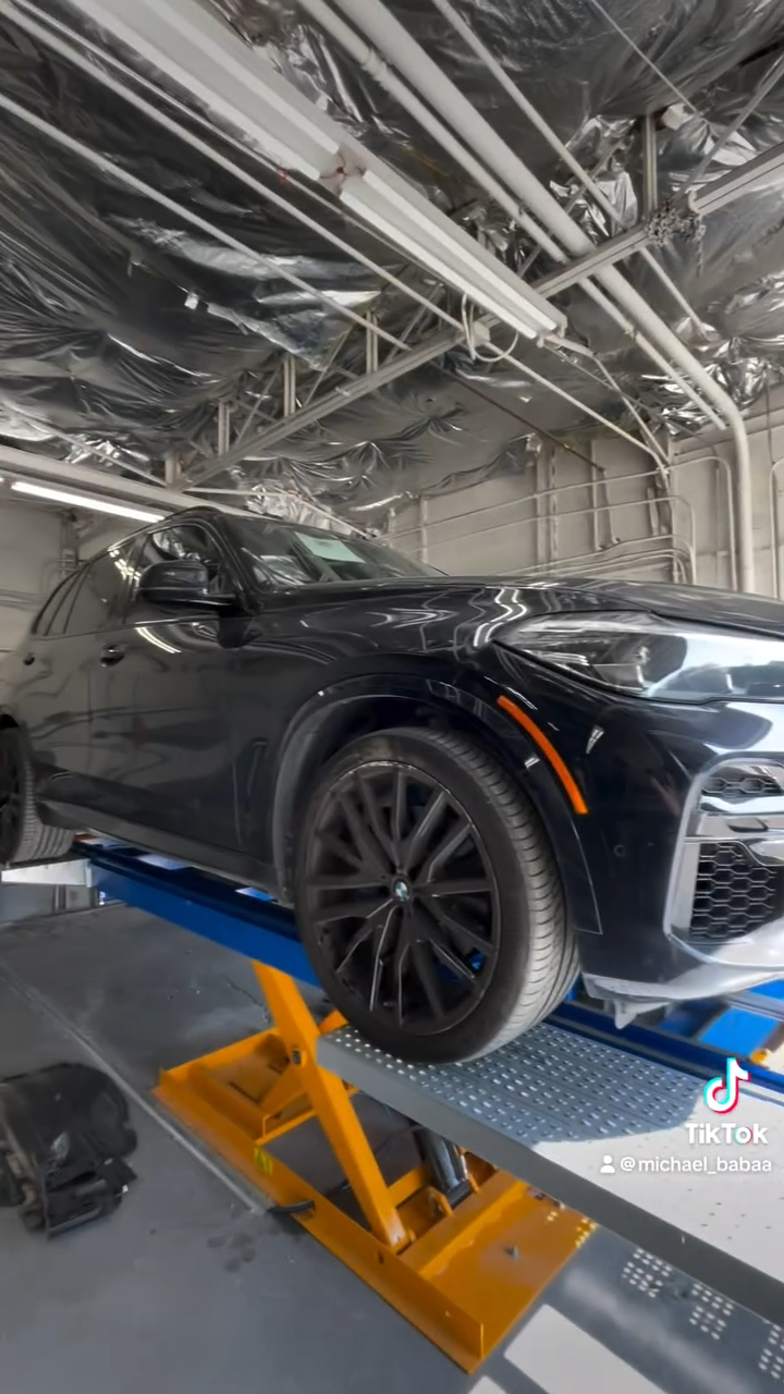 a car on a lift at Auto Body Shop
